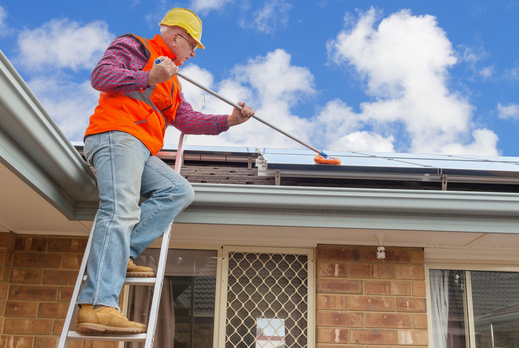 man cleaning solar panels