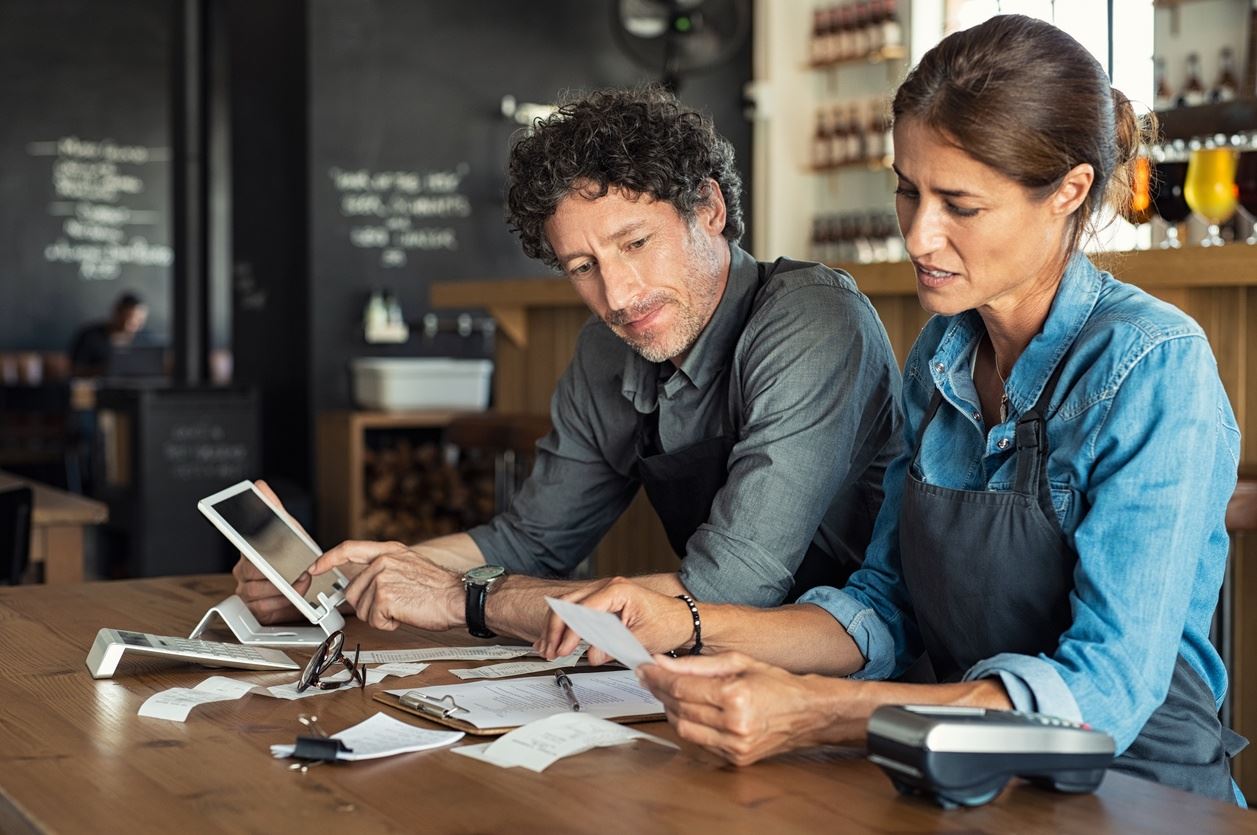 staff at cafe looking at bills