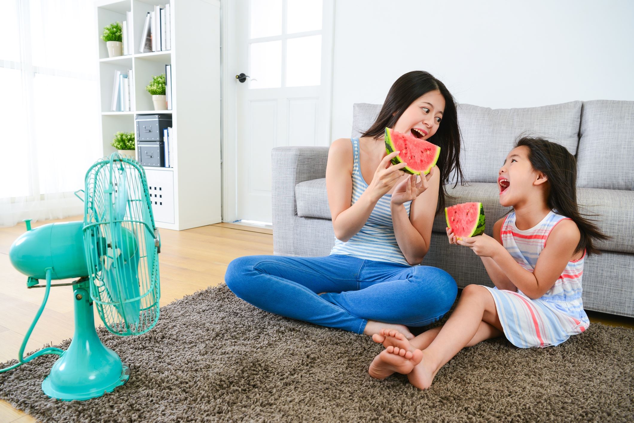 Mum and daughter holding watermelon