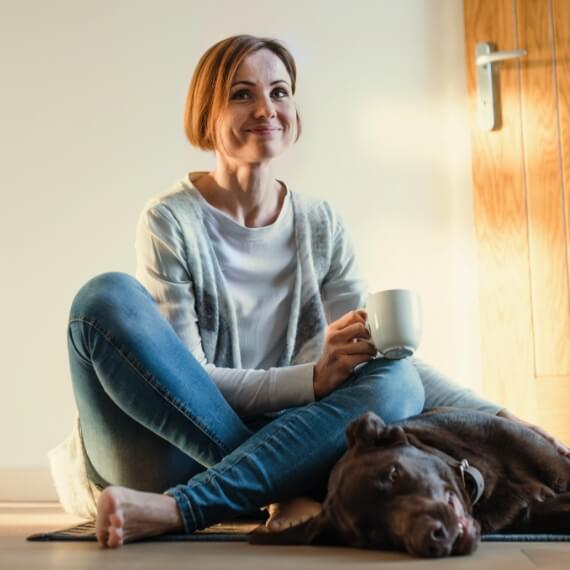 woman with tea and dog