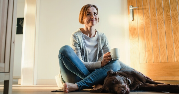 woman with tea and dog